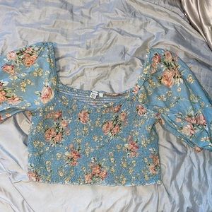 A cropped blue floral shirt